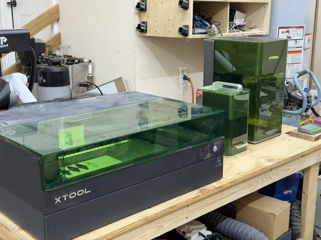 xTool laser machines arranged on the Created Workshop shop bench